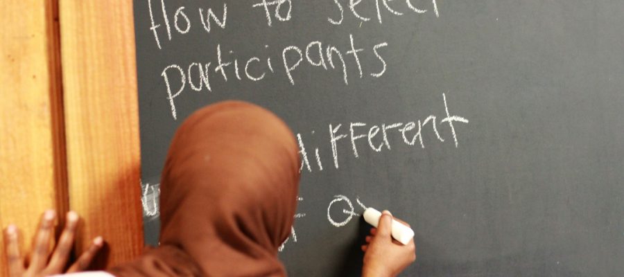 woman writing on a blackboard